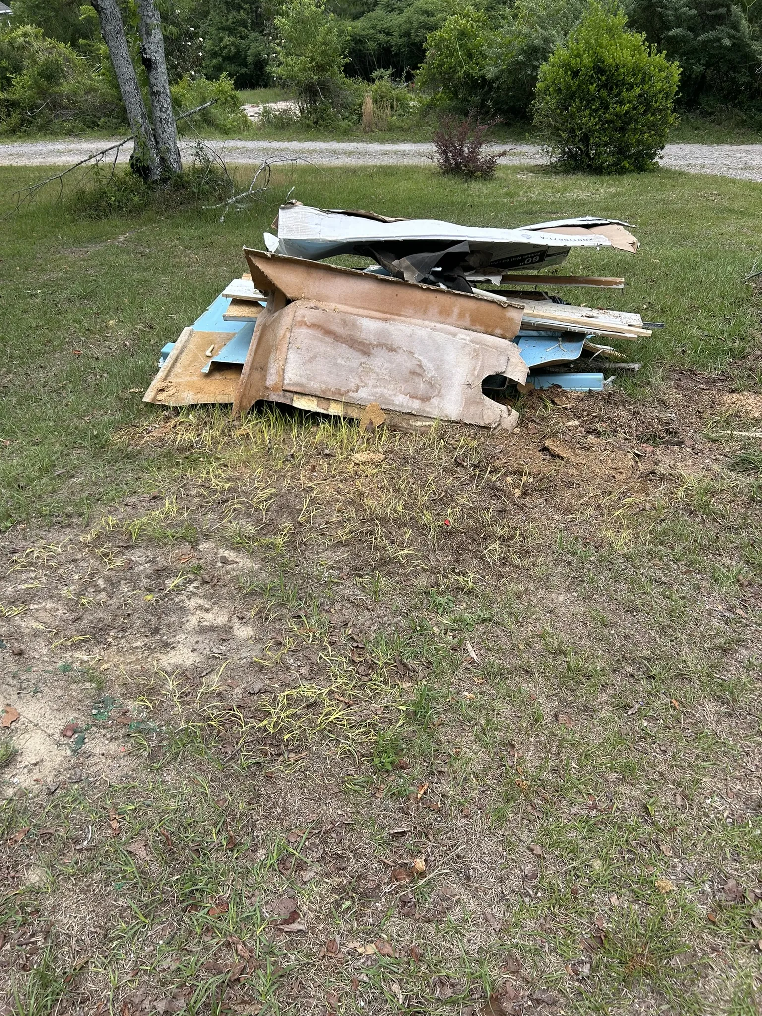 Old wall panels and boards piled on a lawn