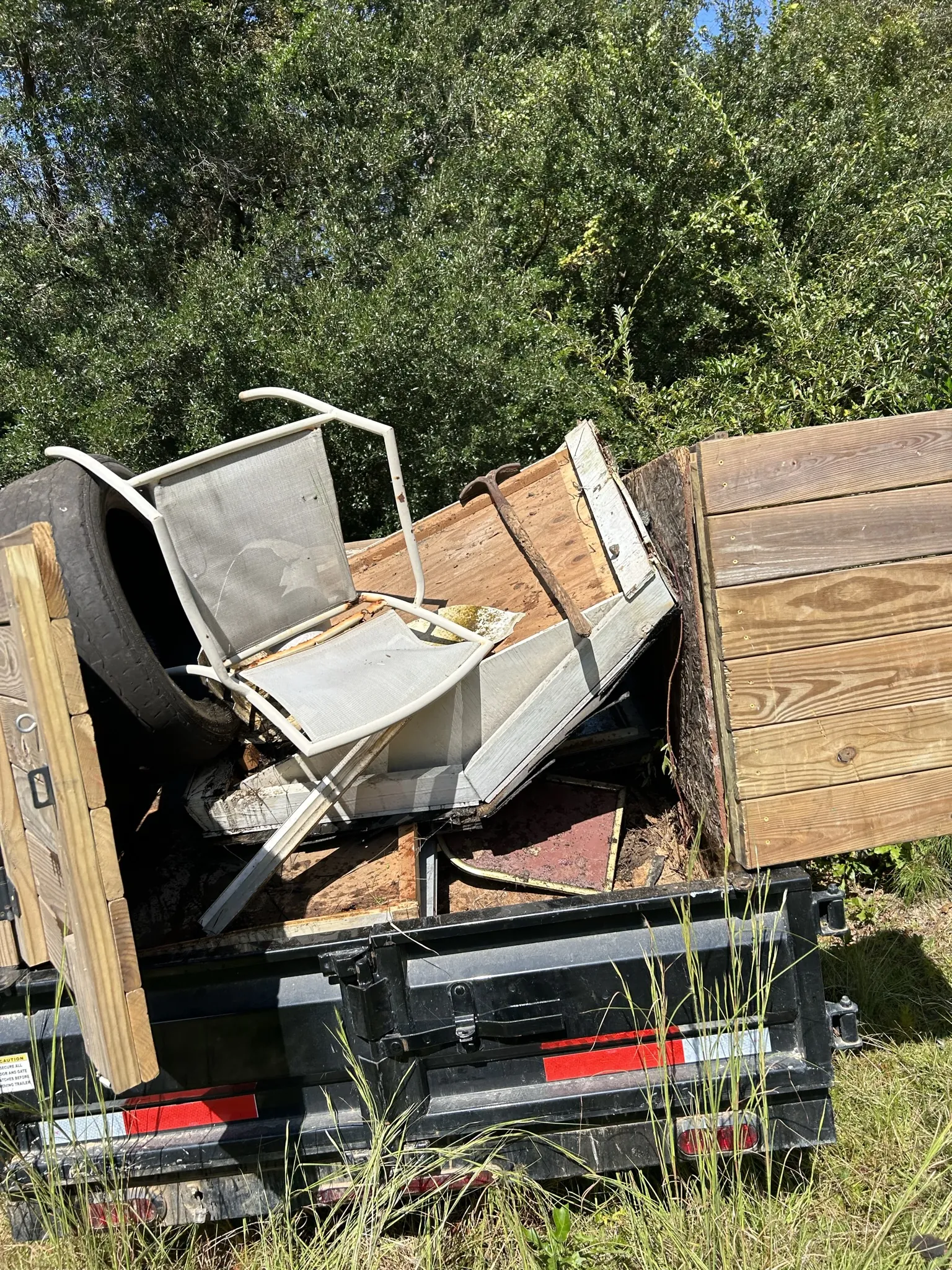 Old chair frames and furniture parts loaded in the dump trailer