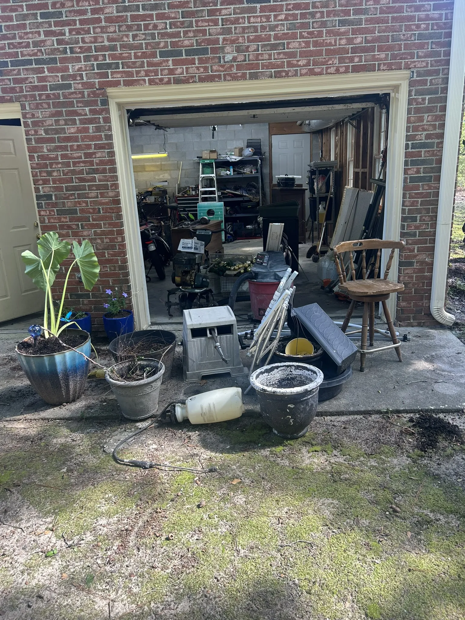 Items pulled out of a garage onto the driveway for pickup