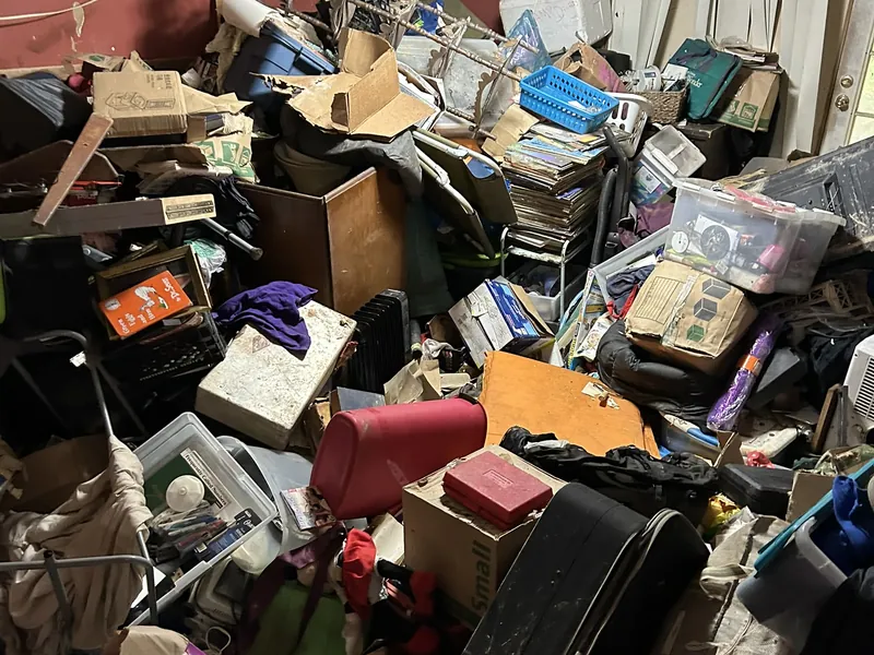 A room packed floor to ceiling with boxes, bins and belongings