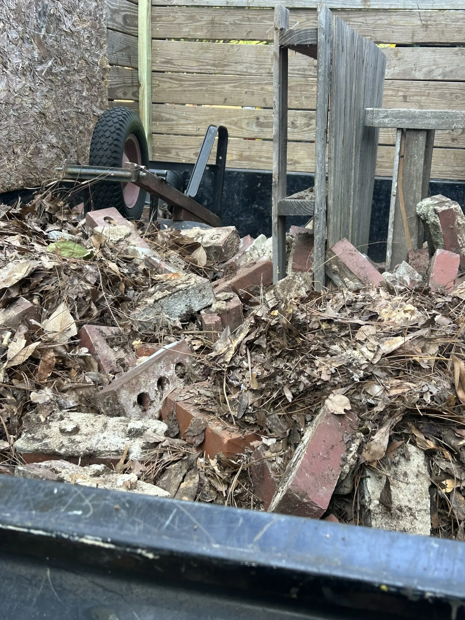 Old bricks and leaves loaded in the dump trailer
