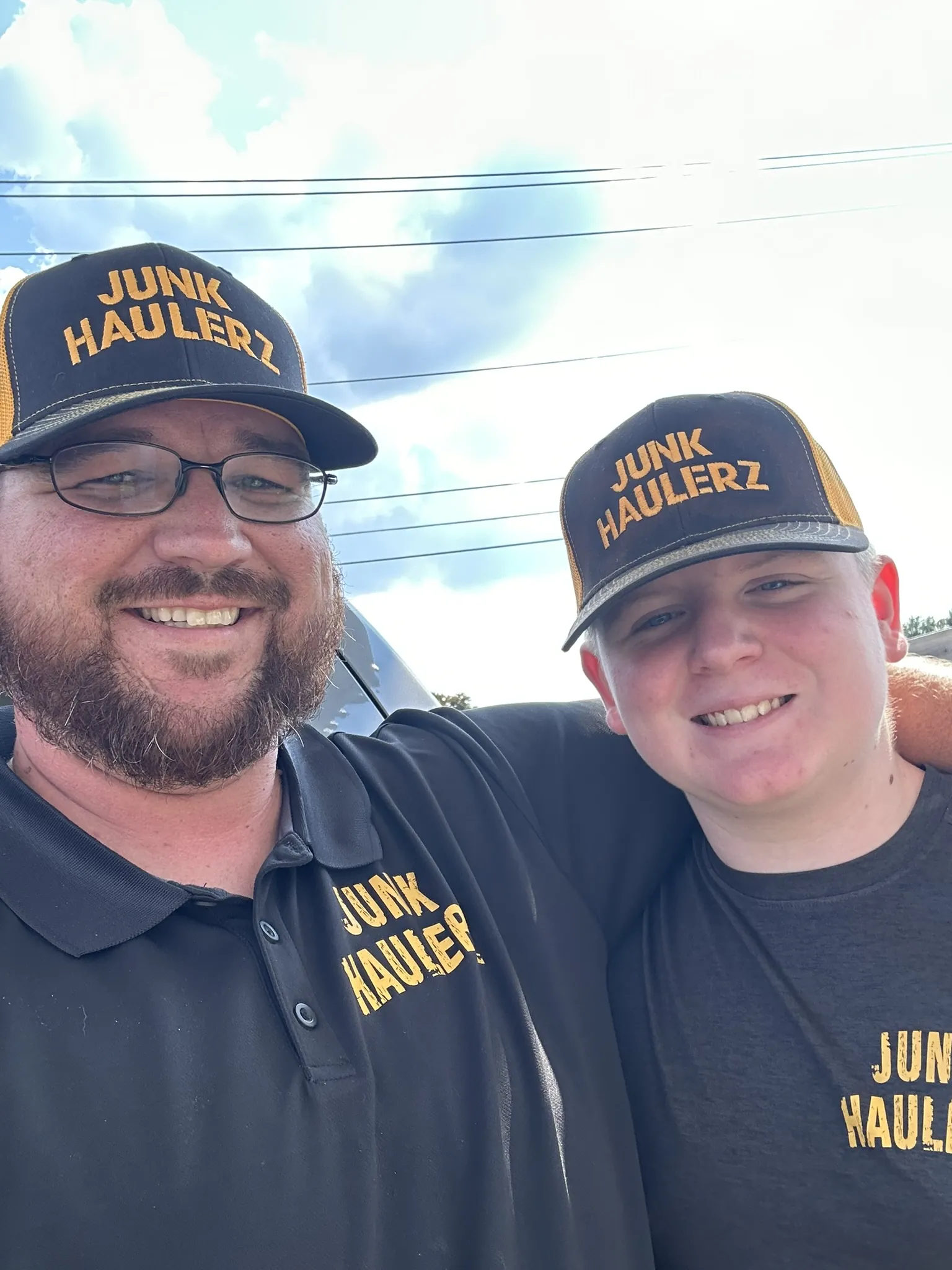 Pat Boatwright and a crew member in Junk Haulerz caps and shirts