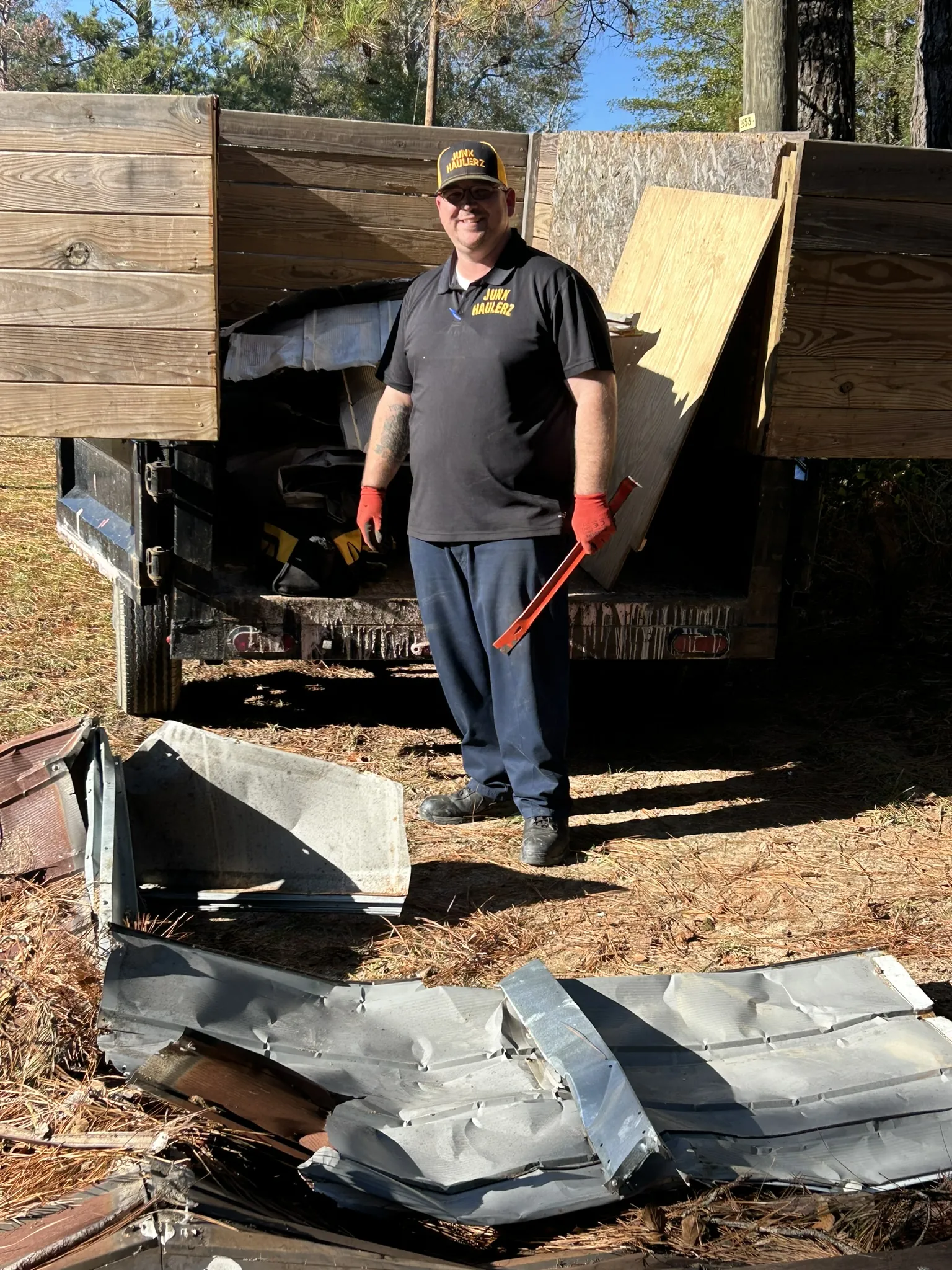 Pat Boatwright standing in the loaded dump trailer with work gloves on
